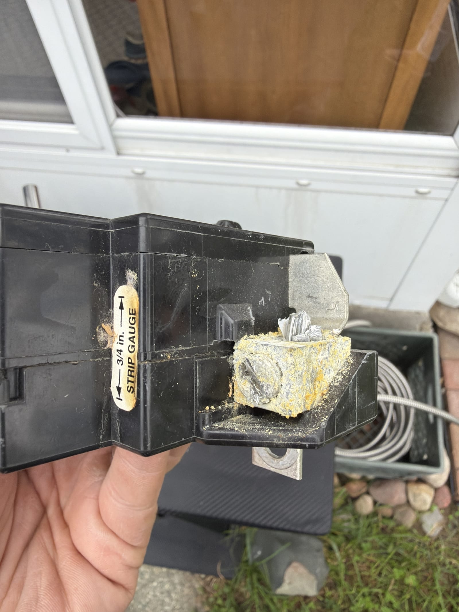 Close-up of a corroded, failing breaker connection removed from an aging Metro Detroit home's electrical panel
