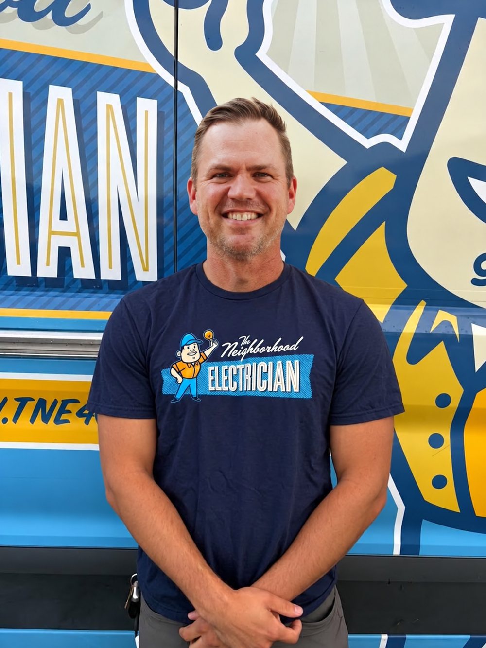 Nate Anderson, licensed master electrician and owner of The Neighborhood Electrician, standing in front of a company van